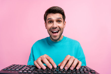Photo portrait of nice young guy excited typing working keyboard computer wear trendy blue garment...