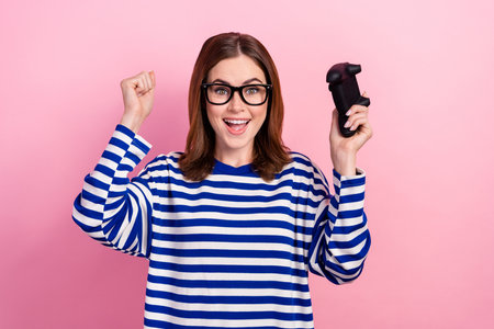 Photo of overjoyed cute lady have fun rejoice win competition finish level hooray yeah isolated on...