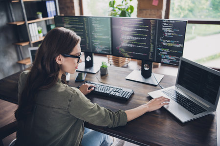 Photo of smart lady nerd working startup site program typing key words open pc upgrade reboot operating system indoor home workstationの写真素材