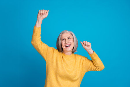Photo portrait of senior gorgeous woman raise fists celebrate win lottery dressed stylish yellow...