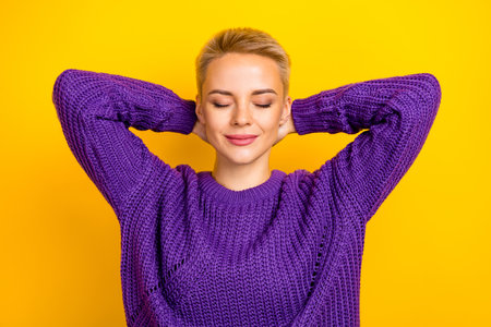 Close up photo of cute lovely lady hold arms behind head imagine weekend summer trip travel abroad isolated on yellow color backgroundの写真素材