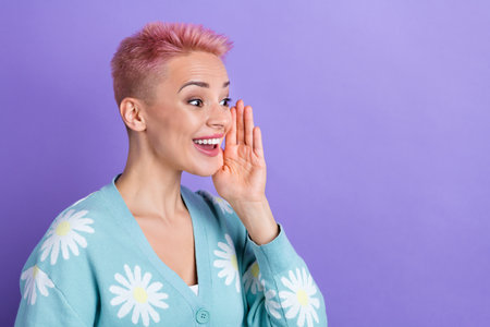 Portrait of positive adorable girl pink hairdo wear blue pullover look empty space palm near cheek...