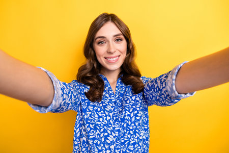 Photo of positive cute lady wear blue clothes isolated on yellow color background