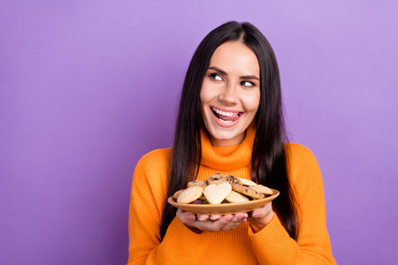 Photo of funny hungry woman brunette hair wear stylish orange sweater tongue out look empty space...