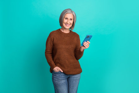 Portrait of cheerful person hold use telephone chatting eshopping isolated on turquoise color...