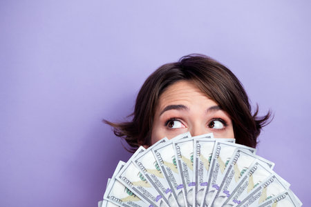Cropped close up photo of successful woman showing salary watching empty space offer isolated on...