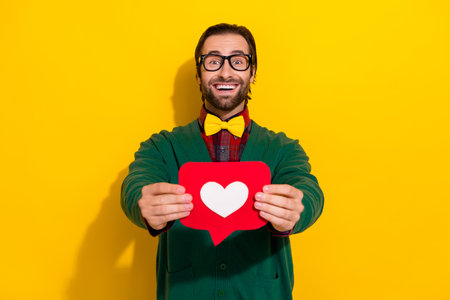 Photo of funny excited guy business developer wear green cardigan stylish bowtie hold red paper...