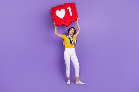 Full length photo of lovely glad stylish lady wear trendy clothes hold big card above head empty...