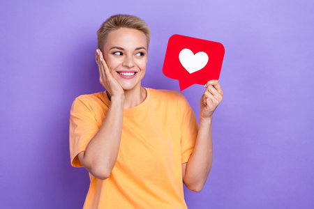 Portrait of cheerful cute girl hand touch cheek look paper like card isolated on purple color...