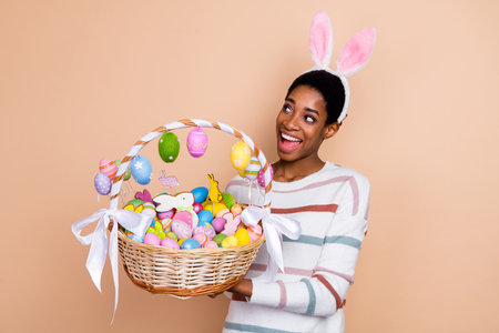 Photo of funny young short hairdo lady hold sweets look promo wear white sweater ears isolated on...
