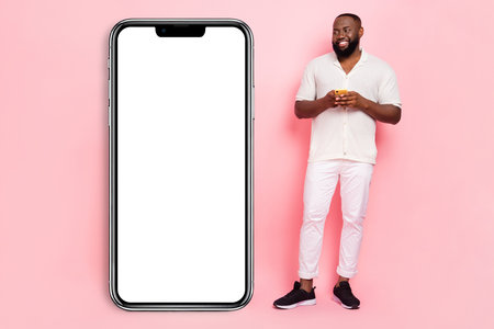 Photo of funky dreamy young man wear white shirt reading modern device empty space isolated pink...