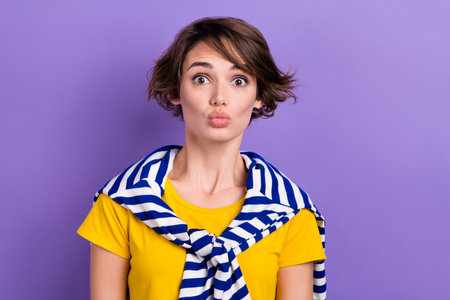 Photo of impressed funny lady dressed tied jumper big eye lips pouted isolated violet color backgroundの写真素材