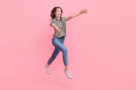 Full length profile portrait of overjoyed carefree person jump rush raise opened arms empty space...