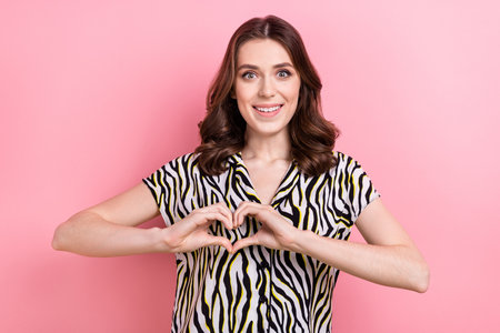 Photo of young excited attractive girl sympathy fingers showing love symbol support poverty donate more money isolated on pink color backgroundの写真素材