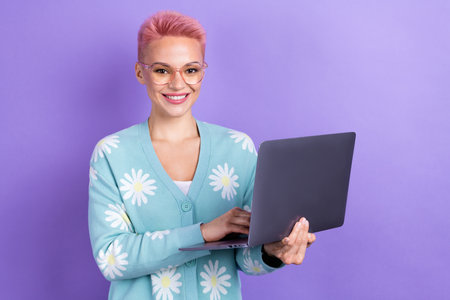 Photo of positive cute intelligent woman with short hairstyle dressed blue cardigan holding laptop...