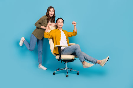 Full body photo poster advert couple students of new luxury chair for working studying comfortable place fists up isolated on blue color backgroundの写真素材