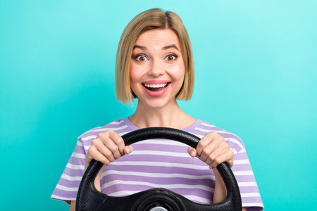 Photo of impressed ecstatic girl striped t-shirt sunglass hold steering wheel astonished staring...