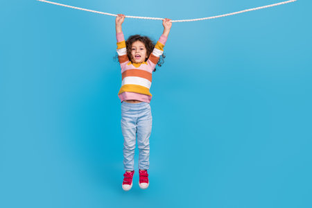 Full body photo picture of funky little young schoolgirl hang rope game competition the strongest...