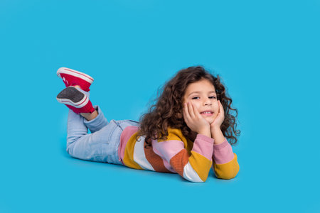Full length photo of cute funny small schoolgirl touch hands cheekbones relax time chilling lying...