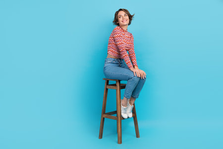 Full length photo of funky dreamy lady wear pink shirt looking back empty space sitting chair...