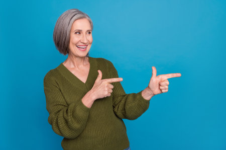 Photo of pleasant cheerful woman bob hairstyle dressed khaki sweater directing look empty space sale...