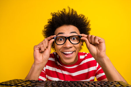 Portrait cheerful funky person hands touch eyeglasses beaming smile pc keyboard isolated on yellow...