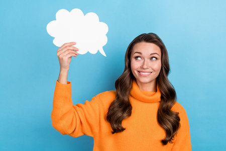 Photo of shiny thoughtful lady wear knitted pullover holding mind cloud empty space isolated blue...