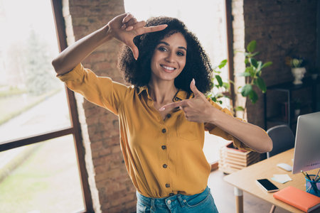 Photo of charming positive recruiter lady toothy smile arms fingers demonstrate cadre gesture loft interior room insideの写真素材