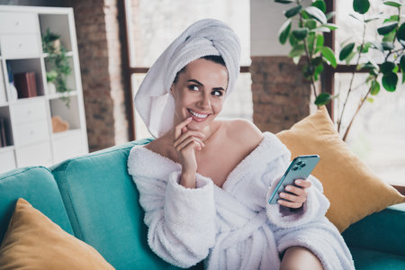 Photo of interested lady sit at comfort cozy home after shower bath use device have thoughts about spa healthcare proceduresの写真素材