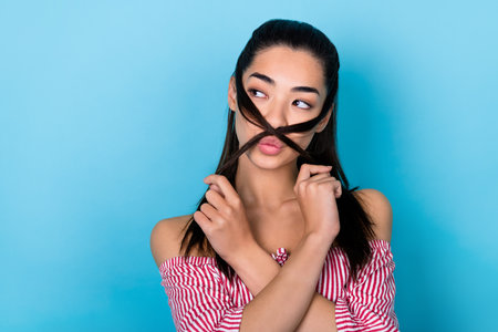 Portrait of korean young girl black hair playful long ponytails pouted blow lips look empty space...
