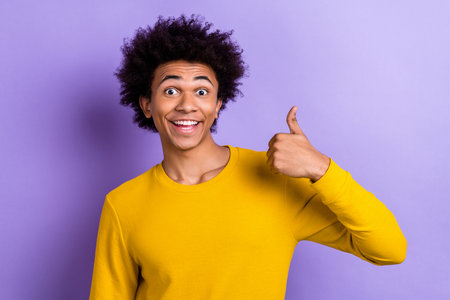 Portrait of cheerful astonished man toothy smile hand finger demonstrate thumb up approve isolated...