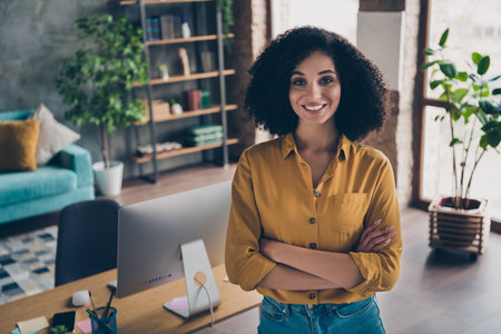 Photo of adorable positive lady recruiter wear shirt arms folded smiling indoors workplace workshopの写真素材