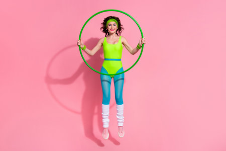 Photo of lady trainer jumping hold training gymnastics isolated on pastel color backgroundの写真素材