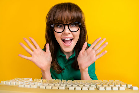 Photo of impressed funny lady wear green shirt texting vintage gadget isolated yellow color...