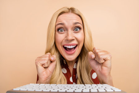 Photo of crazy delighted person raise fists success accomplishment computer keyboard isolated on...