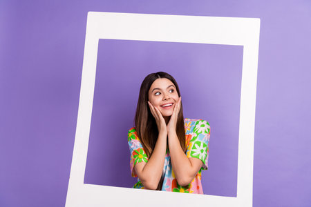 Photo of optimistic girl long hairstyle dressed flower print t-shirt stand in frame look empty space...