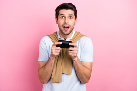 Portrait of funny man confused player videogame hold wireless joystick console lose match isolated...