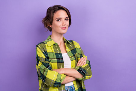 Photo of confident business lady folded arms wear plaid green shirt boss working office administrator isolated on violet color backgroundの写真素材