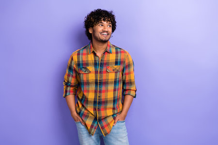 Photo of young guy middle eastern indian guy look empty space wearing plaid stylish casual shirt model isolated on purple color backgroundの写真素材