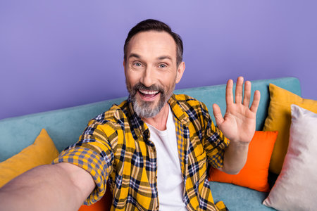 Photo of positive cheerful man influencer wear stylish clothes streaming broadcasting waving arm...