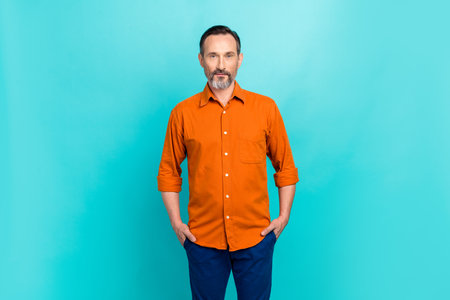 Photo of confident pensioner businessman bank owner posing for his magazine newspaper successful person isolated on cyan color backgroundの写真素材