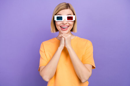 Portrait of ecstatic nice woman with bob hairdo wear stylish t-shirt in 3d glasses arms on chin at cinema isolated on purple backgroundの写真素材