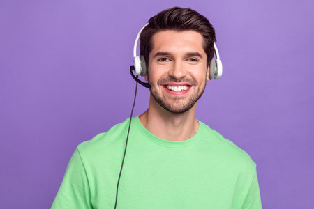 Photo of brunet man wear green stylish t-shirt listen professional gadget headset microphone call...