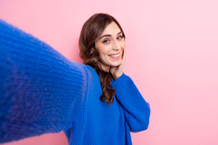 Photo portrait of attractive young woman take selfie photo video streaming wear trendy blue clothes isolated on pink color backgroundの写真素材