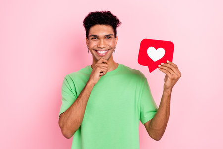 Photo of dreamy thoughtful man dressed green t-shirt arm chin holding feedback card isolated pink...