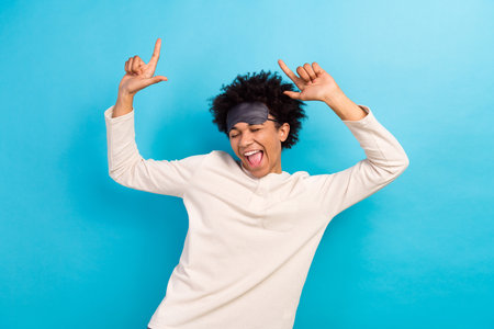 Photo portrait of attractive young man raise hands excited dancing disco dressed white pajama...