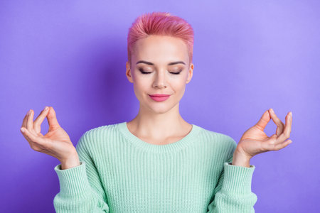 Photo of lovely adorable peaceful girl closed eyes hands fingers meditate isolated on violet color backgroundの写真素材