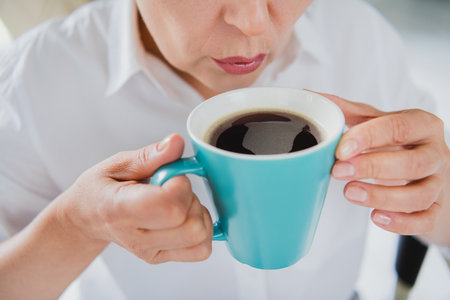 Cropped photo of tired overworked businesswoman lips trying taste sugar beverage coffee espresso morning sleepless isolated in officeの写真素材