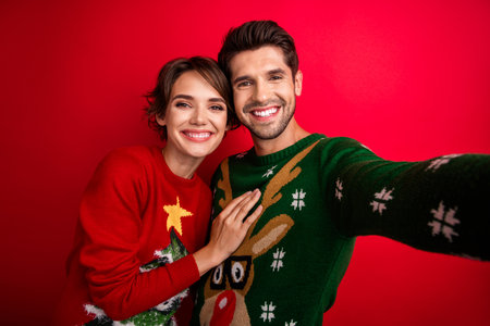Selfie portrait of two married spouses celebrate noel party photographing isolated vivid color...