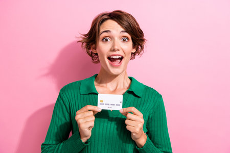 Portrait of impressed woman wear stylish clothes presenting credit card astonished staring open...